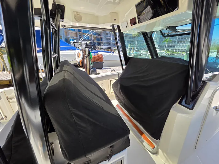 Grey Hawk Yacht Photos Pics 2023 Boston Whaler 360 Outrage interior with covered seats and modern design.