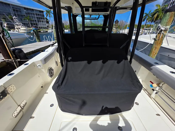 Grey Hawk Yacht Photos Pics 2023 Boston Whaler 360 Outrage boat interior with covered seating, docked at marina.