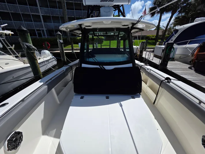 Grey Hawk Yacht Photos Pics 2023 Boston Whaler 360 Outrage boat docked, showcasing spacious deck and modern design.