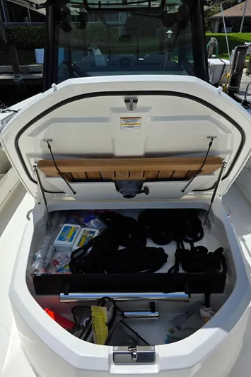 Grey Hawk Yacht Photos Pics 2023 Boston Whaler 360 Outrage storage compartment with various boating accessories.