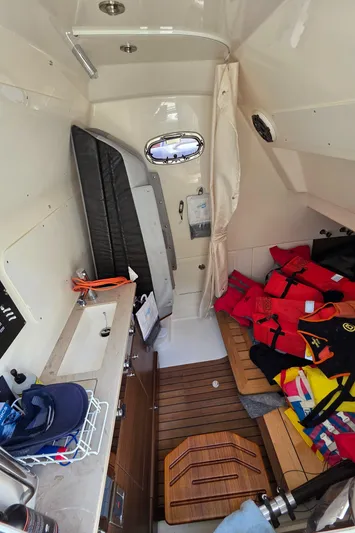 Grey Hawk Yacht Photos Pics 2023 Boston Whaler 360 Outrage cabin interior with life jackets and seating area.