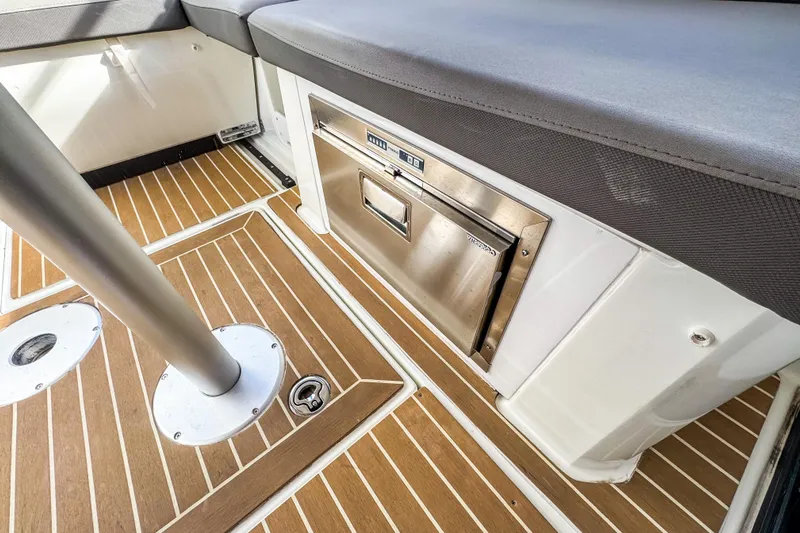  Yacht Photos Pics 2024 Beneteau Antares 11 interior with wood flooring and built-in storage.