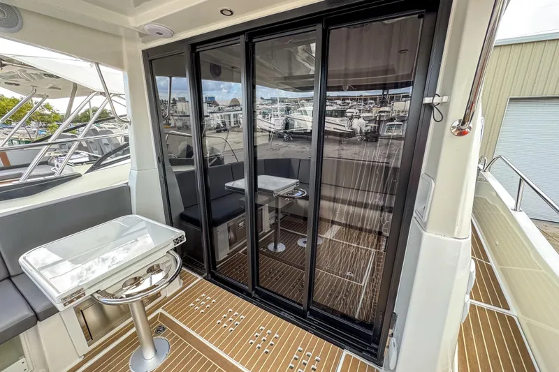  Yacht Photos Pics 2024 Beneteau Antares 11 yacht interior with sliding glass doors and seating area.