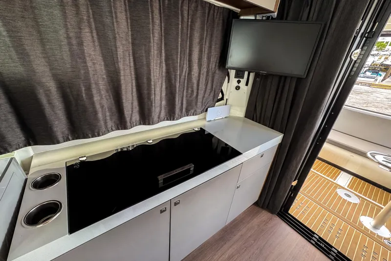  Yacht Photos Pics 2024 Beneteau Antares 11 interior kitchen with modern appliances and sleek design.