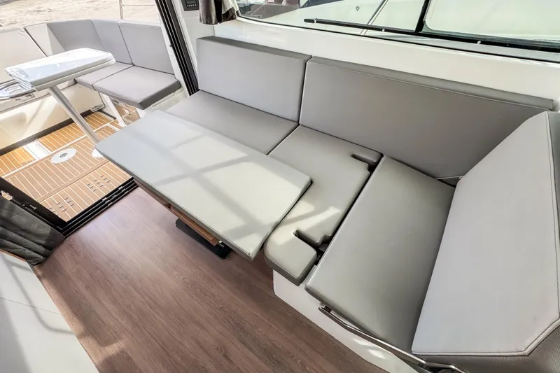  Yacht Photos Pics 2024 Beneteau Antares 11 interior with convertible seating and modern design.