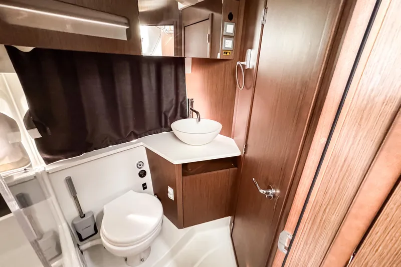  Yacht Photos Pics 2024 Beneteau Antares 11 bathroom with modern fixtures and wood accents.