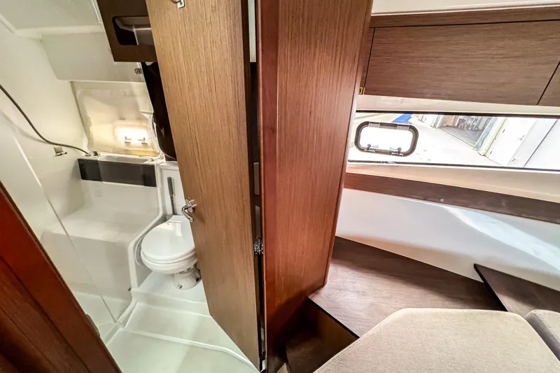  Yacht Photos Pics 2024 Beneteau Antares 11 interior with modern bathroom and wooden finishes.