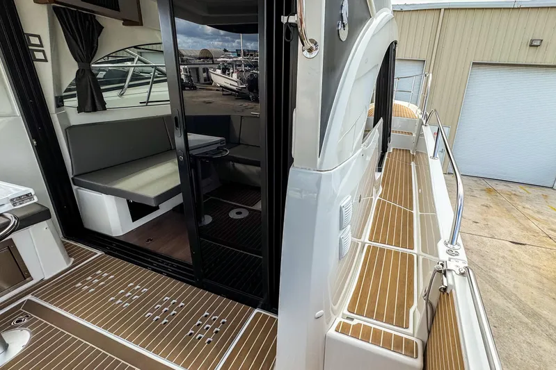  Yacht Photos Pics 2024 Beneteau Antares 11 boat interior with seating and deck view.