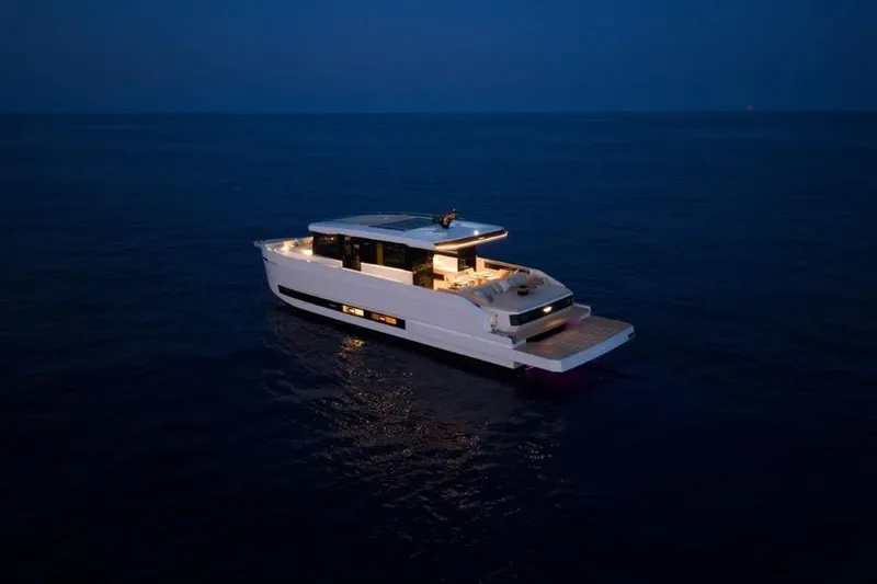  Yacht Photos Pics 2025 De Antonio Yachts D60 cruising at night on calm waters.