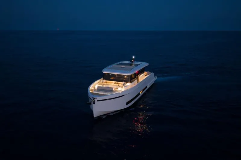  Yacht Photos Pics 2025 De Antonio Yachts D60 cruising at night on open water.