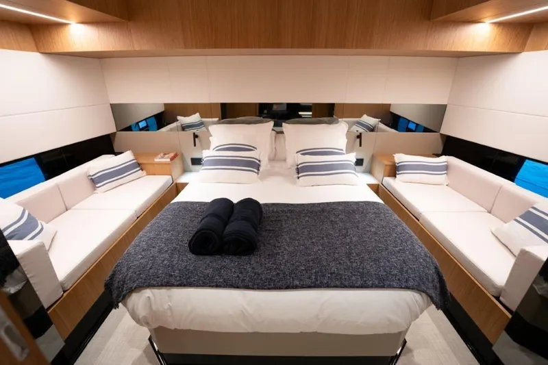  Yacht Photos Pics Luxurious 2025 De Antonio Yachts D60 cabin with elegant bedding and seating.