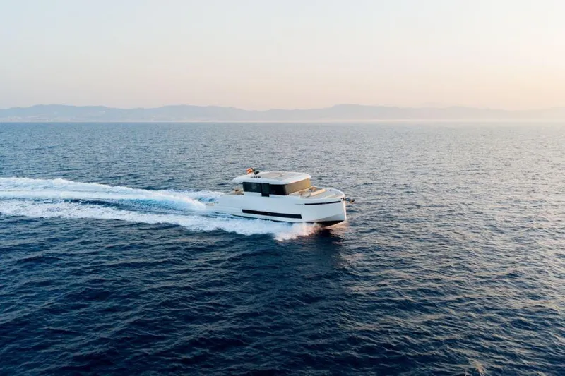  Yacht Photos Pics 2025 De Antonio Yachts D60 cruising on open sea at sunset.