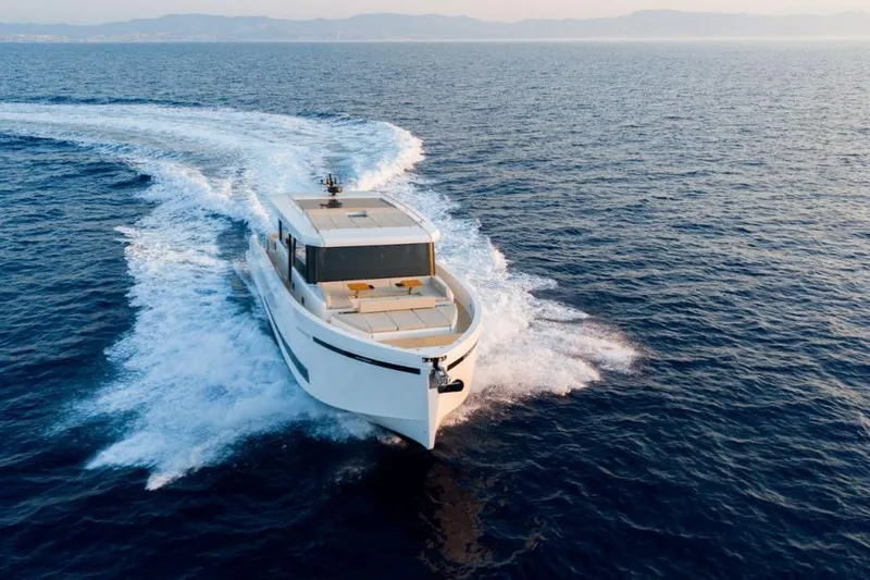  Yacht Photos Pics 2025 De Antonio Yachts D60 cruising on open sea, showcasing sleek design and performance.