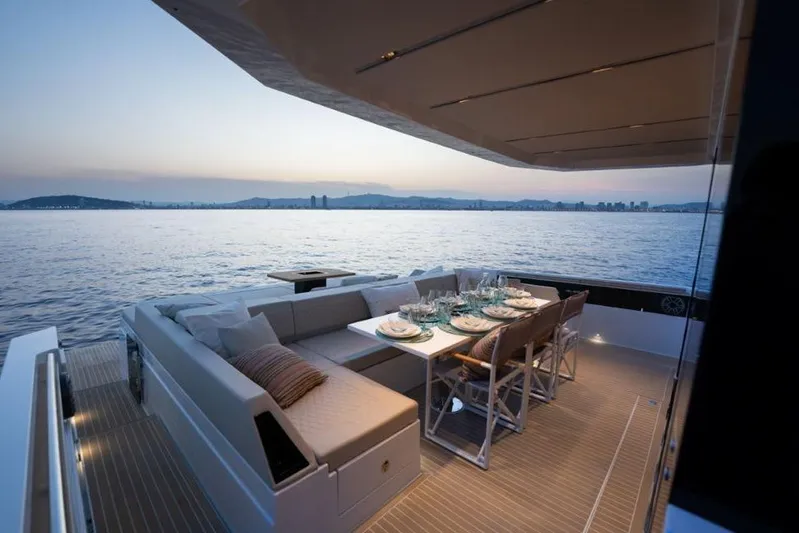  Yacht Photos Pics Luxury dining area on 2025 De Antonio Yachts D60, overlooking serene ocean sunset.