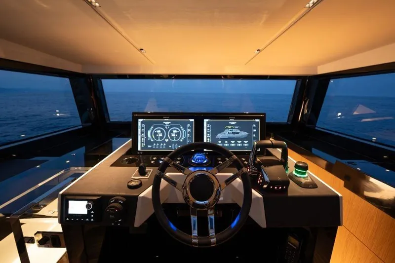 Yacht Photos Pics 2025 De Antonio Yachts D60 helm with modern navigation screens and ocean view.