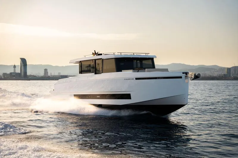  Yacht Photos Pics 2025 De Antonio Yachts D60 cruising on open water at sunset.