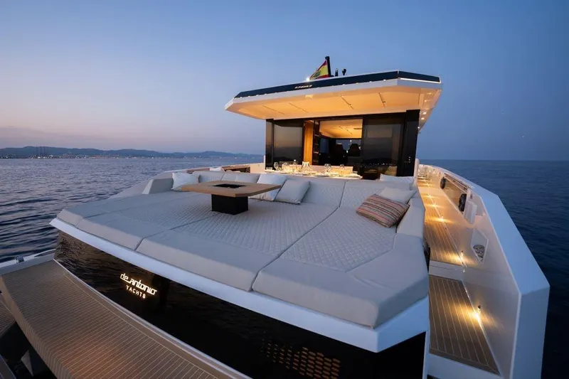  Yacht Photos Pics Luxurious 2025 De Antonio Yachts D60 at sunset, featuring spacious deck and elegant design.
