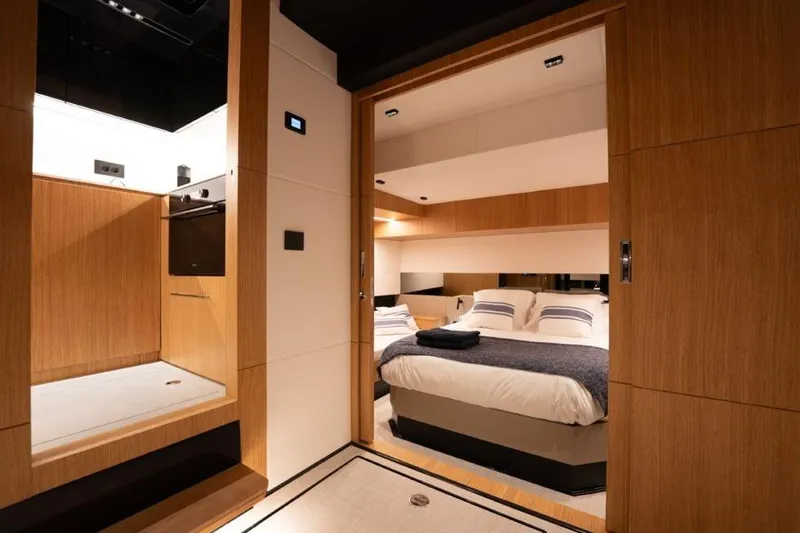  Yacht Photos Pics Luxurious interior of 2025 De Antonio Yachts D60, featuring a cozy bedroom and modern kitchen.
