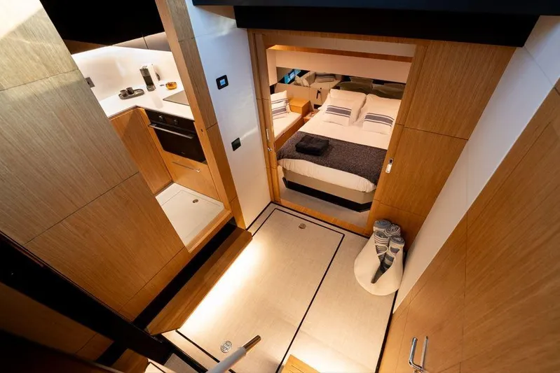  Yacht Photos Pics Luxurious interior of 2025 De Antonio Yachts D60, featuring a cozy bedroom and modern kitchen.