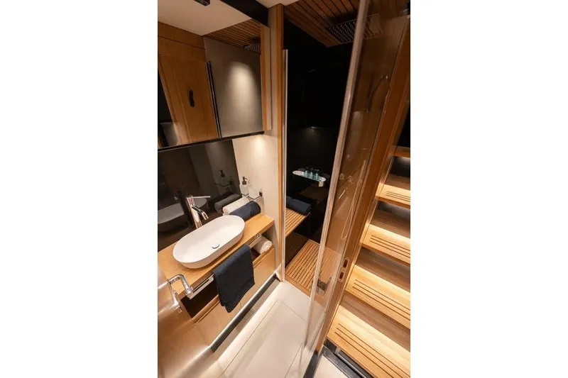  Yacht Photos Pics Luxurious bathroom interior of 2025 De Antonio Yachts D60, featuring modern design and wooden accents.