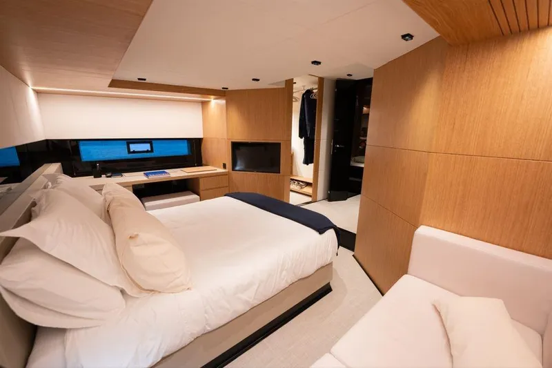  Yacht Photos Pics Luxurious interior of 2025 De Antonio Yachts D60, featuring a modern bedroom with wood accents.