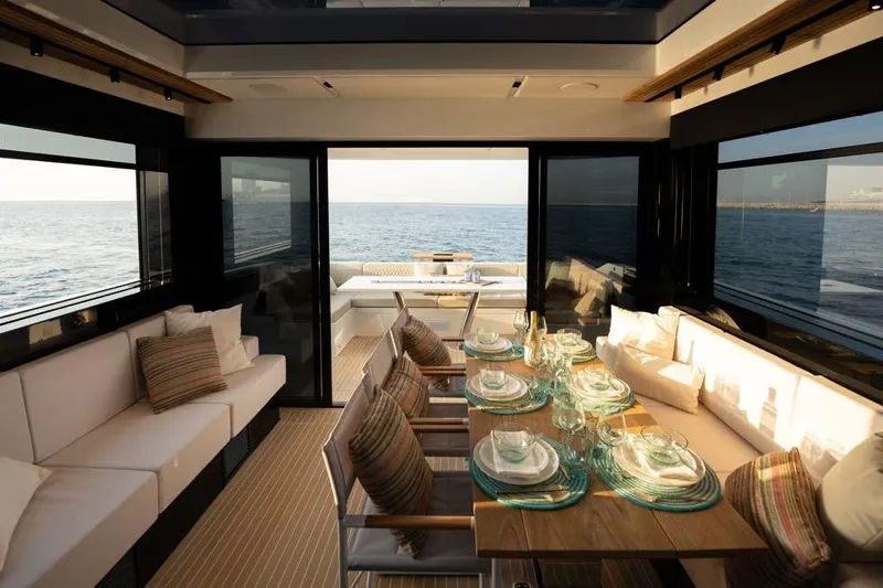  Yacht Photos Pics Luxurious interior of 2025 De Antonio Yachts D60 with elegant dining setup and ocean view.