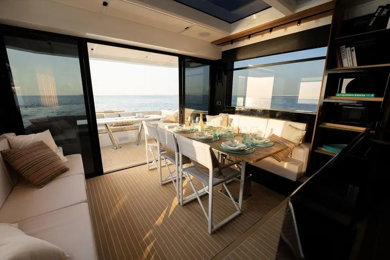  Yacht Photos Pics Luxurious interior of 2025 De Antonio Yachts D60 with elegant dining setup and ocean view.