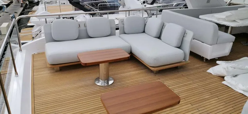 Goldinia Yacht Photos Pics Luxury seating area on 2021 Azimut 72 yacht with wooden deck and modern furniture.