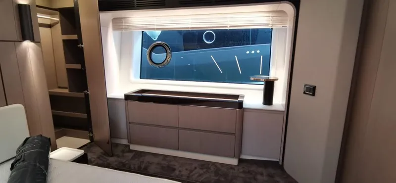 Goldinia Yacht Photos Pics Luxurious interior of 2021 Azimut 72 yacht with modern furnishings and large window.