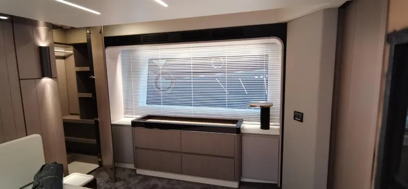 Goldinia Yacht Photos Pics Luxurious interior of a 2021 Azimut 72 yacht with modern cabinetry and window blinds.