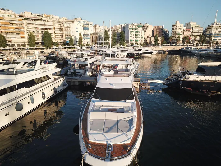 Goldinia Yacht Photos Pics Luxury 2021 Azimut 72 yacht docked in a bustling marina.