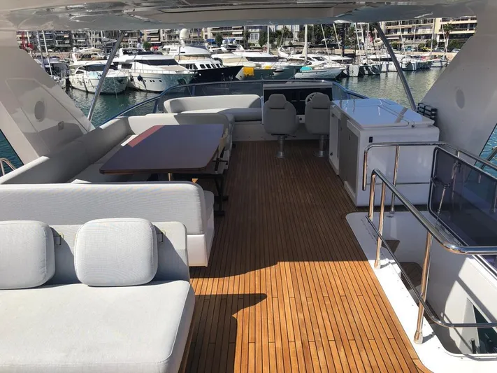 Goldinia Yacht Photos Pics Luxurious 2021 Azimut 72 yacht deck with elegant seating and marina view.