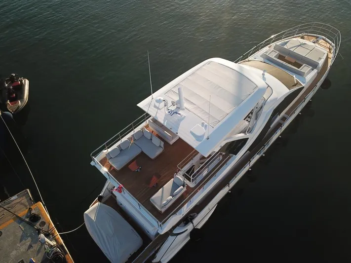 Goldinia Yacht Photos Pics Aerial view of 2021 Azimut 72 yacht docked, showcasing spacious deck and sleek design.