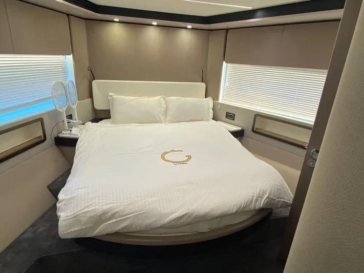 Goldinia Yacht Photos Pics Luxurious bedroom interior of 2021 Azimut 72 yacht with elegant bedding and modern design.