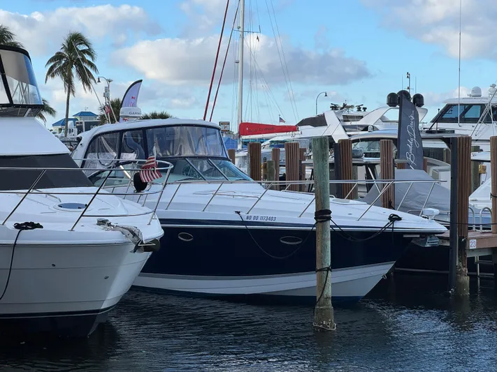  Yacht Photos Pics 2004 Formula 40 PC yacht docked at marina with palm trees and cloudy sky.
