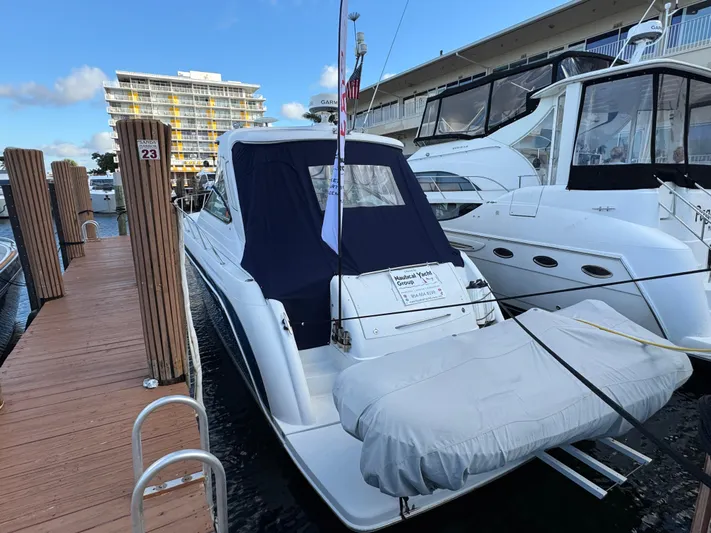  Yacht Photos Pics 2004 Formula 40 PC yacht docked at marina, covered dinghy attached, clear sky background.