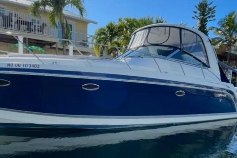  Yacht Photos Pics 2004 Formula 40 PC boat docked near tropical waterfront home.