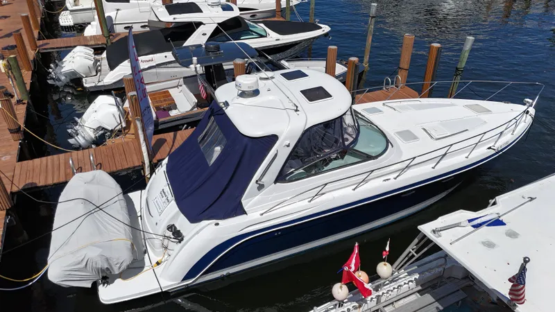  Yacht Photos Pics 2004 Formula 40 PC yacht docked at marina, featuring sleek design and blue canopy.