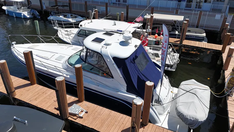  Yacht Photos Pics 2004 Formula 40 PC yacht docked at marina, featuring sleek design and covered seating area.