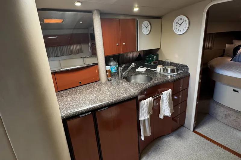  Yacht Photos Pics 2004 Formula 40 PC yacht interior with kitchenette, featuring sink, cabinets, and modern amenities.