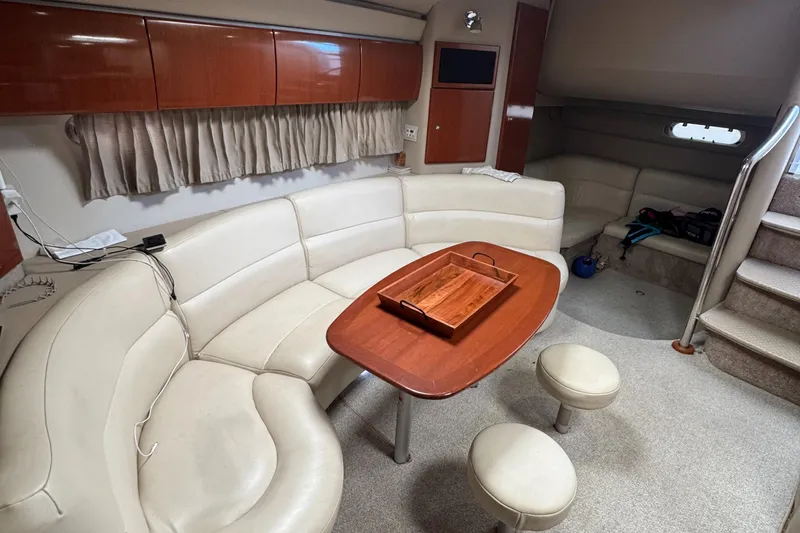  Yacht Photos Pics Interior of 2004 Formula 40 PC yacht with cream seating and wooden table.