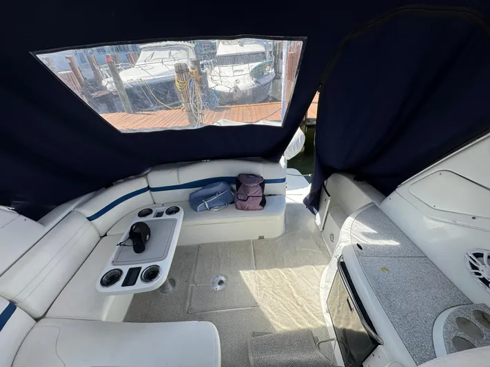  Yacht Photos Pics Interior of 2004 Formula 40 PC boat with seating and table, docked at marina.