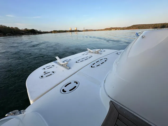  Yacht Photos Pics 2006 Sea Ray 58 Sedan Bridge yacht on calm water, rear deck view.