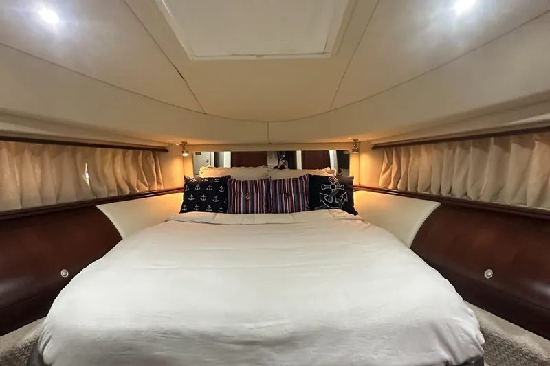  Yacht Photos Pics Luxurious bedroom interior of 2006 Sea Ray 58 Sedan Bridge yacht with elegant bedding.