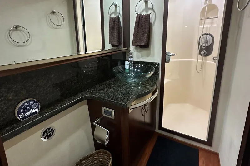  Yacht Photos Pics Luxurious bathroom in 2006 Sea Ray 58 Sedan Bridge yacht with glass sink and shower.