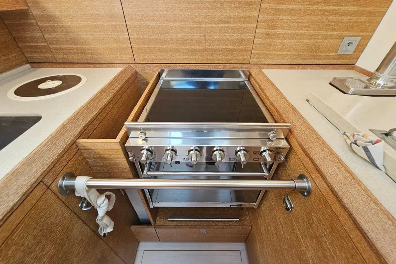 Cnb 60 Yacht Photos Pics Modern kitchen in 2013 CNB BORDEAUX 60 yacht with sleek stove and wooden cabinetry.