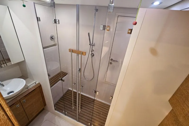 Cnb 60 Yacht Photos Pics Luxurious bathroom in 2013 CNB BORDEAUX 60 yacht with glass shower and wooden accents.