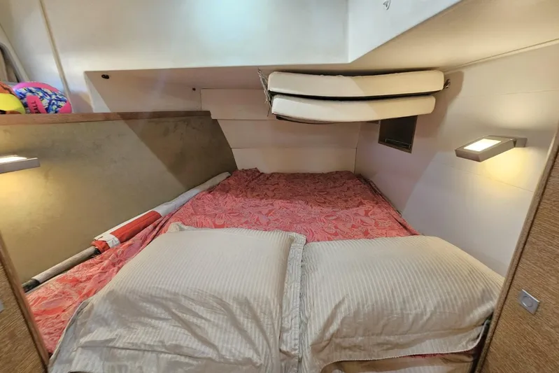 Cnb 60 Yacht Photos Pics Cozy cabin interior of 2013 CNB BORDEAUX 60 yacht with red bedding and soft lighting.