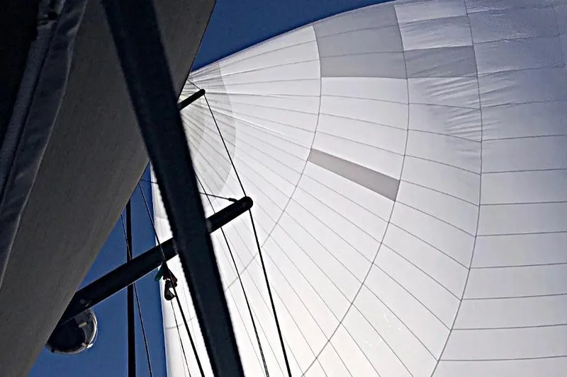 Cnb 60 Yacht Photos Pics Sail of CNB BORDEAUX 60 yacht, 2013 model, against a clear blue sky.