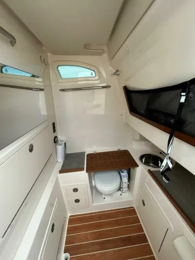  Yacht Photos Pics 2019 Grady-White 306 CANYON boat cabin interior with compact amenities.